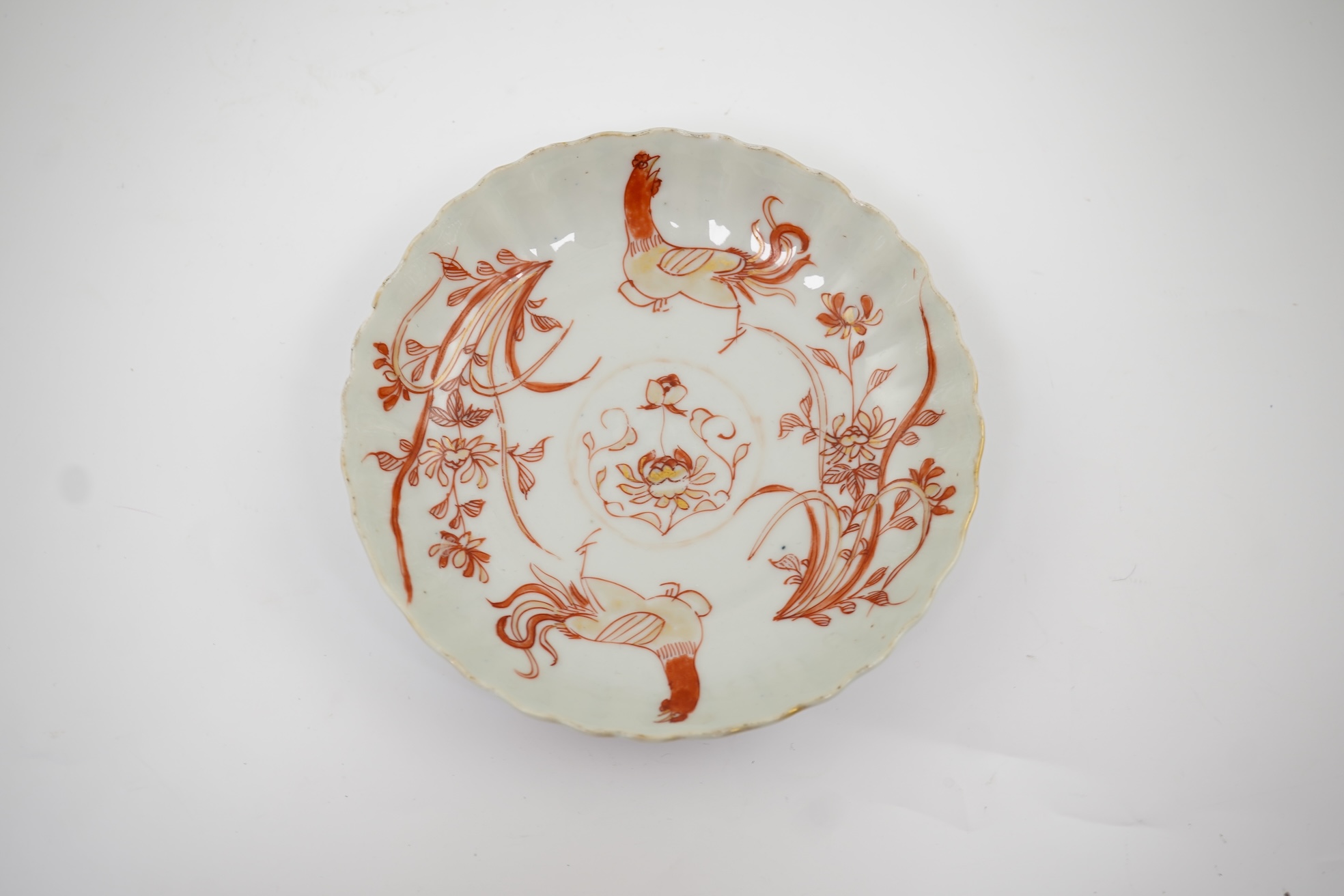 A Chinese rouge de fer tea bowl and saucer and a similar cup, Qianlong period